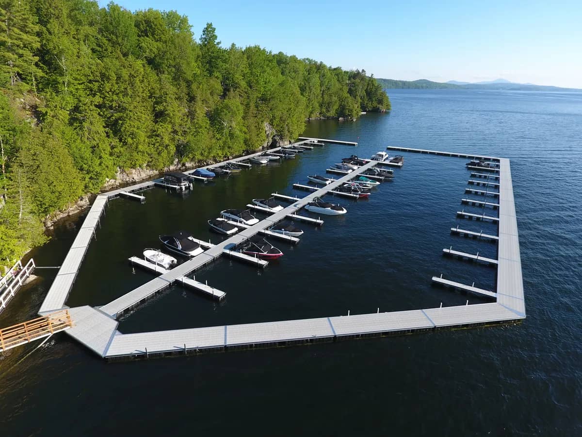 Floating marina docks on a lake surrounded by mountains